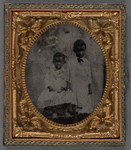 Portrait of Two Children, Seated and Standing With Hand Resting on Companion's Leg