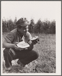 Bud Kimberley eating watermelon. Jasper County, Iowa