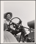 Bud Kimberley drives tractor. Jasper County, Iowa