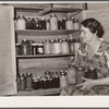 Mrs. Andy Bahain with fruit and vegetables produced on their farm near Kersey, Colorado