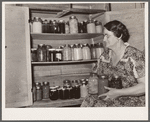 Mrs. Andy Bahain with fruit and vegetables produced on their farm near Kersey, Colorado