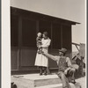 Mr. and Mrs. Calvin Brown and grandson on the steps of their house near Eaton, Colorado. FSA (Farm Security Administration) borrowers