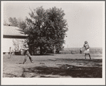Teacher supervises ball game during recess period. Grundy County, Iowa