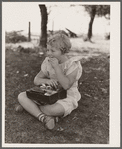 Schoolgirl, pupil of one-room schoolhouse, eating lunch. Grundy County, Iowa