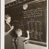 Lois Slinker teaching the only pupil in the second grade in one-room schoolhouse. Grundy County, Iowa