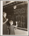 Lois Slinker teaching the only pupil in the second grade in one-room schoolhouse. Grundy County, Iowa