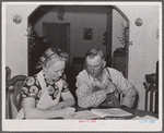 Mr. and Mrs. Fred Maschman going over their record book discuss ways of making their new farm, purchased with FSA (Farm Security Administration) aid, more profitable. Iowa County, Iowa