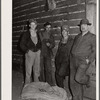 The gleaners, men who gather the ears left by the picker. Cornhusking contest. Marshall County, Iowa