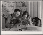 Fred Wilfang, rehabilitation client, goes over his farm plan with his wife. They have twenty hogs, ten milk cows, 250 chickens, a tractor, a bull and 500 quarts of canned goods. Black Hawk County, Iowa