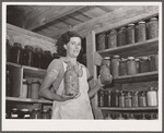 Mrs. Lawrence Corda, wife of tiff miner, with some of her 800 quarts of food canned under supervision of FSA (Farm Security Administration). Washington County, Missouri