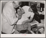 Dentist participating in FSA (Farm Security Administration) health program treats rehabilitation client. Saint Charles County, Missouri