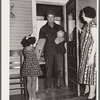Farmer arrives home after shopping in town. Greene County, Missouri