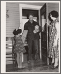 Farmer arrives home after shopping in town. Greene County, Missouri