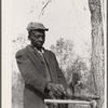 Evicted sharecropper fixes his axe. Butler County, Missouri