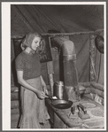 Daughter of evicted sharecropper preparing dinner. Butler County, Missouri