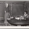 Daughter of evicted sharecropper sets table for dinner. Butler County, Missouri