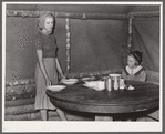 Daughter of evicted sharecropper sets table for dinner. Butler County, Missouri