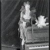 Publicity photograph of Helen Morgan sitting on a piano for the stage production Show Boat