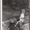 Daughter of evicted sharecropper getting water at spring. Butler County, Missouri