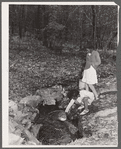 Daughter of evicted sharecropper getting water at spring. Butler County, Missouri