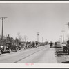 Farmer's cars line the highway near Zimmerman farm auction. Hastings, Nebraska