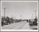 Farmer's cars line the highway near Zimmerman farm auction. Hastings, Nebraska