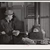 Assayer places crucible containing gold ore in furnace. El Dorado Canyon, Clark County, Nevada