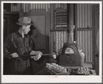 Assayer places crucible containing gold ore in furnace. El Dorado Canyon, Clark County, Nevada