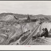 Workers sitting at edge of copper pit. Ruth, Nevada