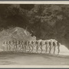 Chorus girls in bathing suits on the beach viewed from the mouth of a cave in the motion picture The Folly of Vanity