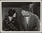 Laura La Plante and Edward Everett Horton (in bowler hat) and  in the motion picture Poker Faces