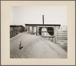 Sand piled up in front of outhouse on farm. Cimarron County, Oklahoma