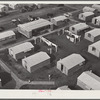 Woodville, California. FSA (Farm Security Administration) farm workers' community. Metal shelters are grouped about the utility building
