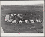 Woodville, California. FSA (Farm Security Administration) farm workers' community. Metal shelters are grouped around the central utility building