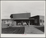 Woodville, California. FSA farm workers' community. The entrance at the central section of the community building. This high central section is the main auditorium. The rooms open off the auditorium and are used for school and various meetings