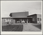 Woodville, California. FSA farm workers' community. The entrance at the central section of the community building. This high central section is the main auditorium. The rooms open off the auditorium and are used for school and various meetings