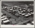 Woodville, California. FSA (Farm Security Administration) farm workers' community. Metal shelters for migrant agricultural workers are grouped about the utility building