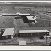 Woodville, California. FSA (Farm Security Administration) farm workers' community. Community buildings in the background, office building and staff automobile garages in the foreground