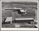 Woodville, California. FSA (Farm Security Administration) farm workers' community. Community buildings in the background, office building and staff automobile garages in the foreground