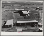 Woodville, California. FSA (Farm Security Administration) farm workers' community. Community buildings in the background, office building and staff automobile garages in the foreground