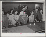 Woodville, California. FSA (Farm Security Administration) farm workers' community. Migrant agricultural workers eating hamburgers at the Saturday night dance