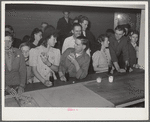 Woodville, California. FSA (Farm Security Administration) farm workers' community. Migrant agricultural workers eating hamburgers at the Saturday night dance