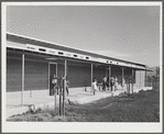 Woodville, California. FSA (Farm Security Administration) farm workers' community. Outside passageways are an important feature of the community building which is used as a school