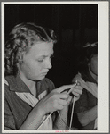 Girl scout learning to knit.  FSA Farm Workers Camp, Tulare County, California