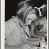 Tulare County, California. FSA (Farm Security Administration) farm workers' camp. Girls reading a copy of Popular mechanics
