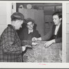 Tulare County, California. FSA (Farm Security Administration) farm workers' camp. Stamping a man's hand as he enters the movies