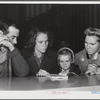 Woodville, California. FSA (Farm Security Administration) farm workers' community. Family group studying first aid lesson