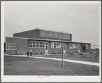 Woodville, California. FSA (Farm Security Administration) farm workers' community. Side view of the community building. Low rooms are used for school and various meetings. The higher central section is the main auditorium