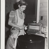 Woodville, California. FSA (Farm Security Administration) farm workers' community. Wife and son of an agricultural laborer who are permanent residents and live in one of the garden houses