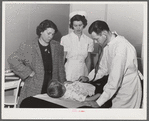 Woodville, California. FSA (Farm Security Administration) farm workers' community. Doctor examining child of agricultural workers at the clinic